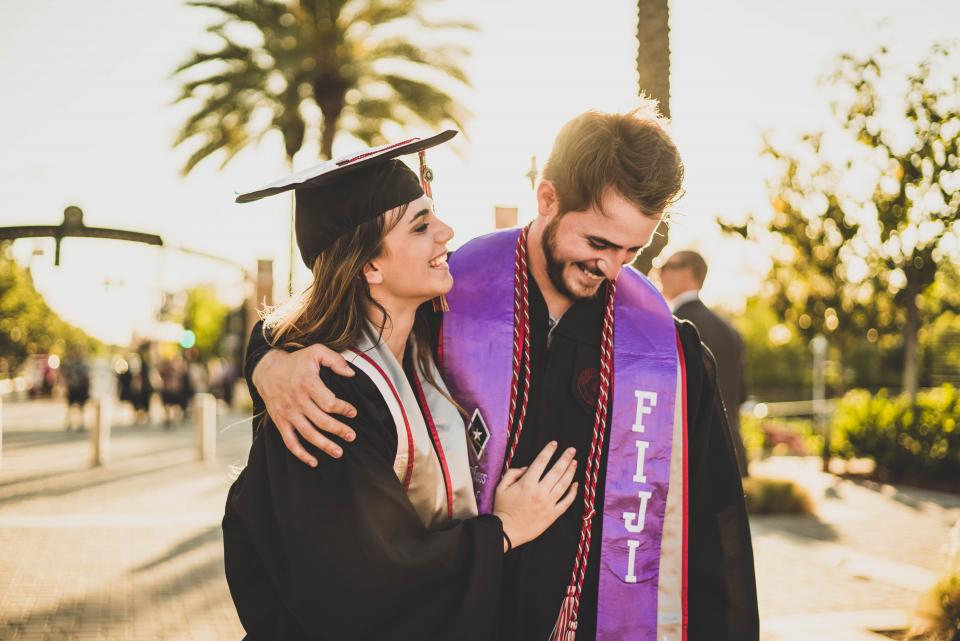 Sesión de graduación: pareja de egresados abrazados